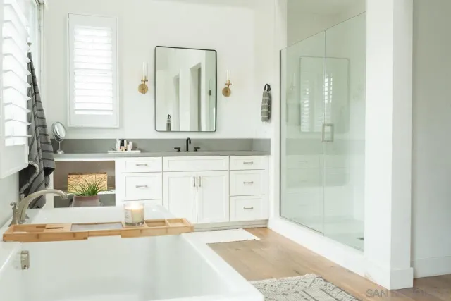 a bathroom with a tub sink and mirror