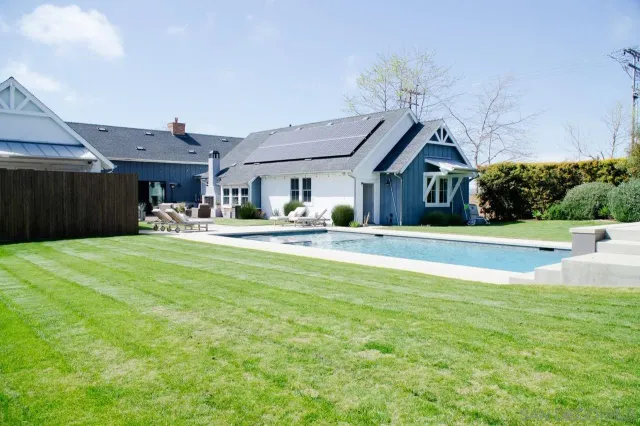 a front view of a house with garden and patio