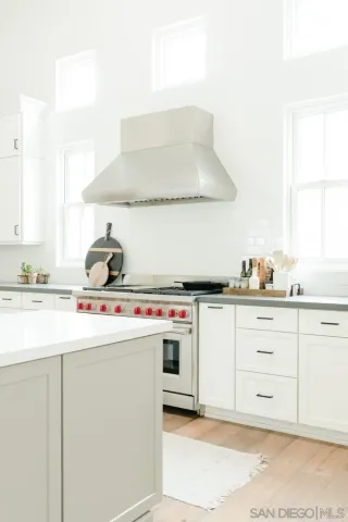 a kitchen with cabinets appliances a sink and a stove