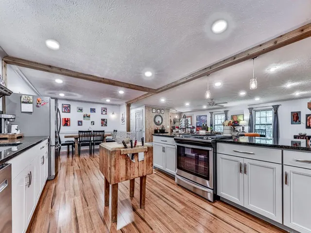a kitchen with lots of counter top space and stainless steel appliances