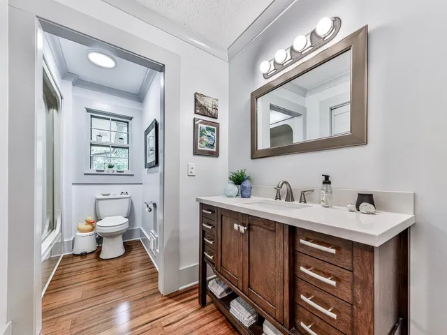 a en suite bathroom with a toilet sink and mirror