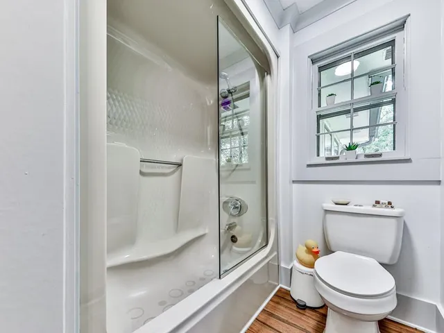 a bathroom with a toilet and a shower