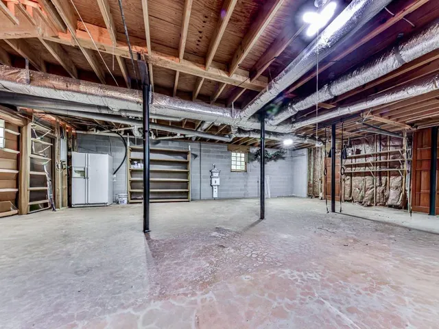 a view of empty room with refrigerator