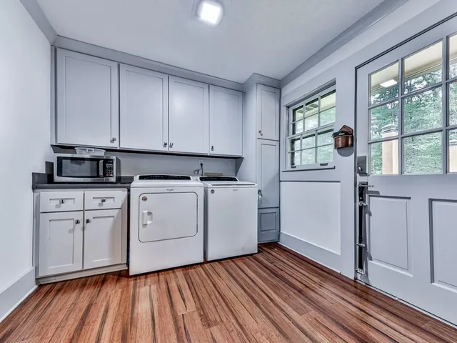 a view of kitchen with wooden floor and electronic appliances