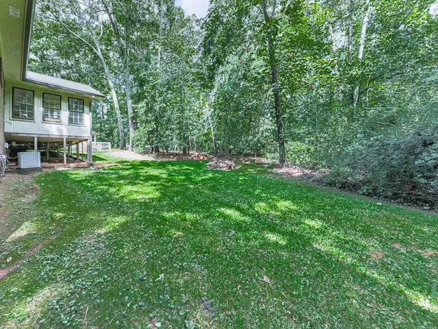 a view of house with backyard