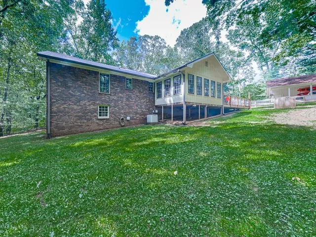 a front view of a house with a garden and trees