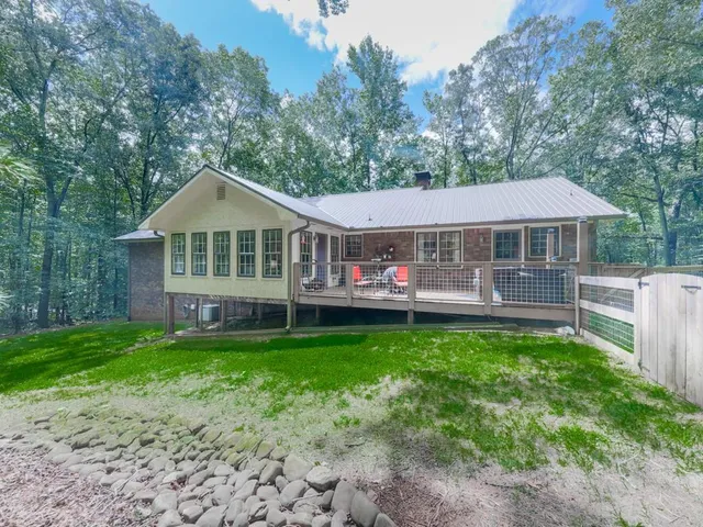 a front view of a house with a yard table and chairs