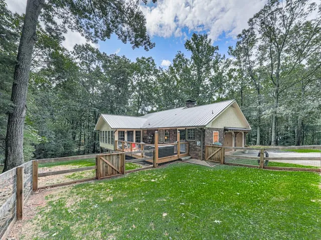 a view of a house with a backyard and a patio