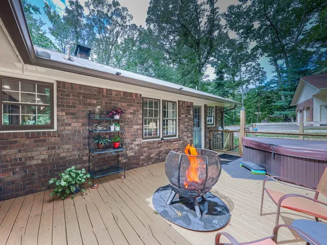 a view of a house with backyard sitting area and furniture