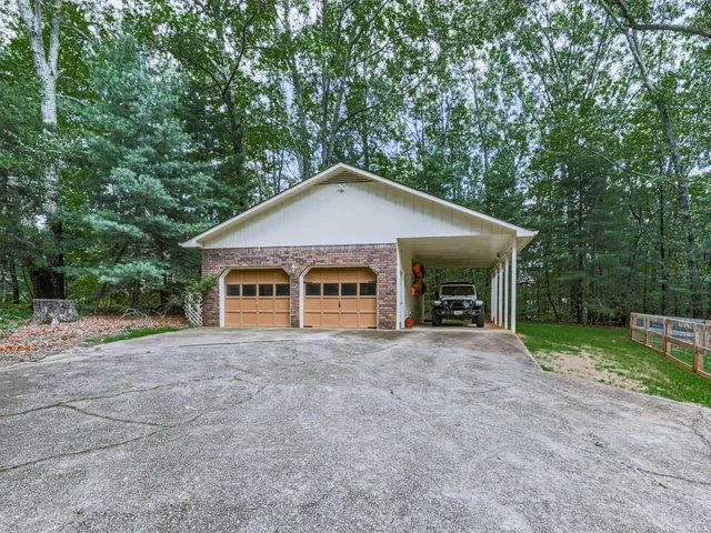 a front view of a house with yard and green space