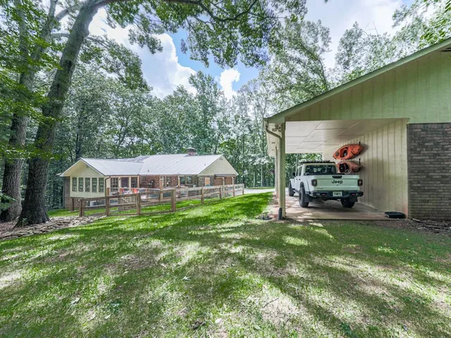 a view of a house with a yard and sitting area