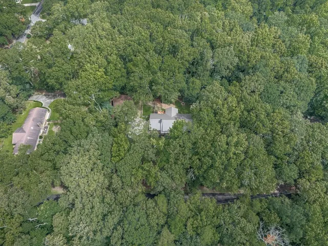 an aerial view of a house with a yard