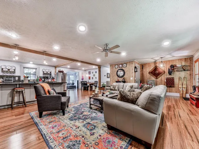 a living room with furniture and a wooden floor