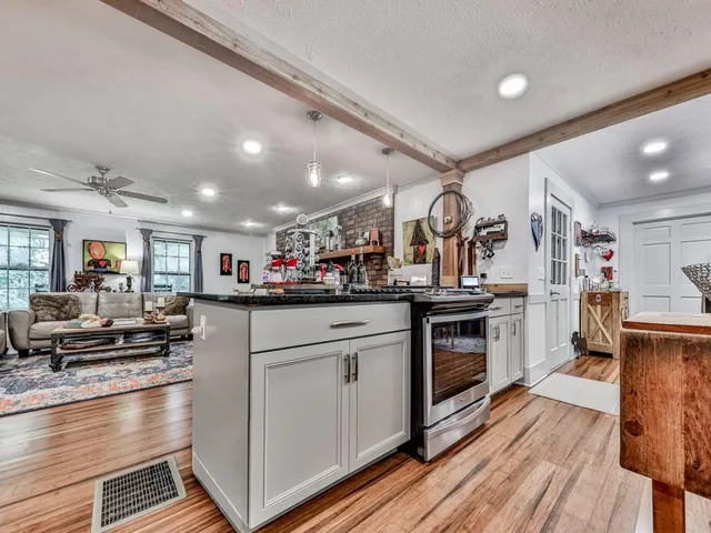 a kitchen with stainless steel appliances granite countertop a stove and a refrigerator