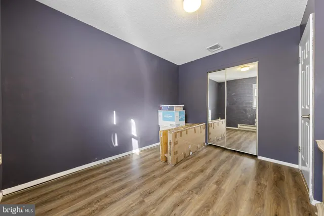 a room with a dresser and a wooden floor
