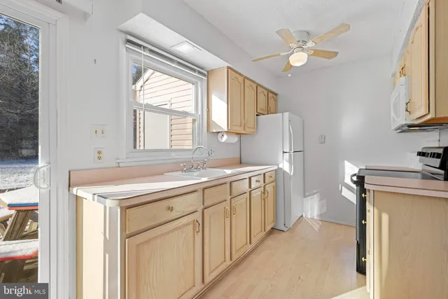 a utility room with cabinets washer and dryer