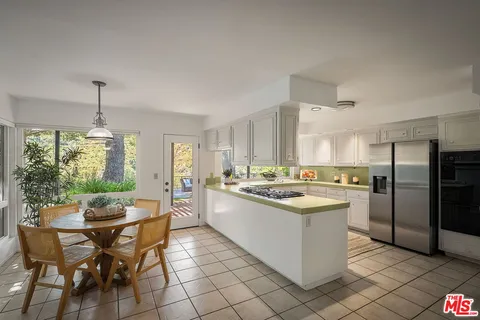 a dining room with furniture window and outside view