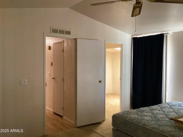 a room with a granite countertop sink and a mirror