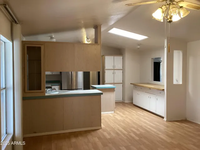 a view of a kitchen with a stove cabinets and a wooden floor