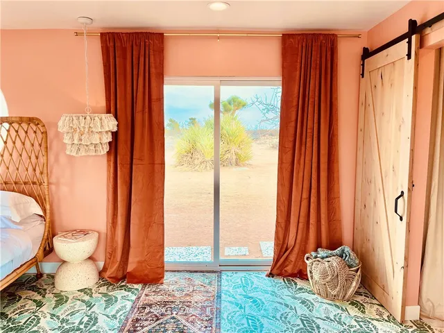 a bedroom with a bed and a mirror