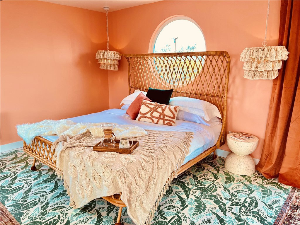 56345 Moonstone Road Yucca Valley, CA 92284 - Photo 18 of 69 a bedroom with a bed and a mirror