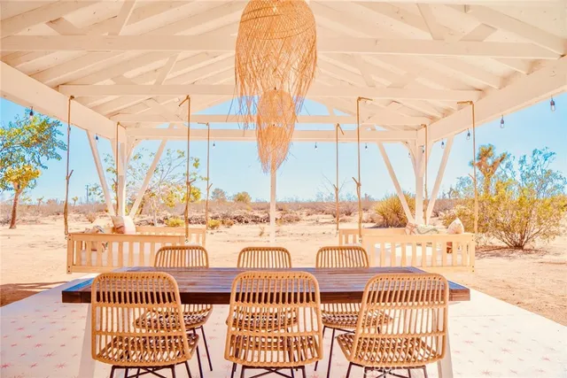 a room with lots of white walls and a potted plant
