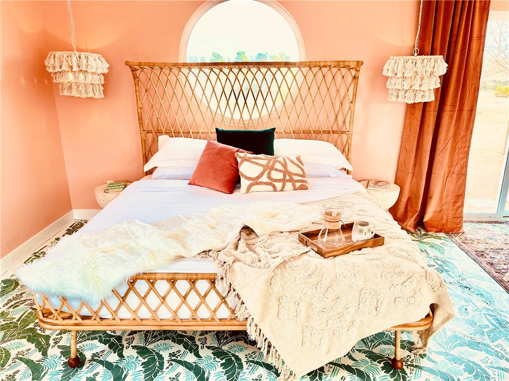 56345 Moonstone Road Yucca Valley, CA 92284 - Photo 7 of 69 a bedroom with a bed and a table