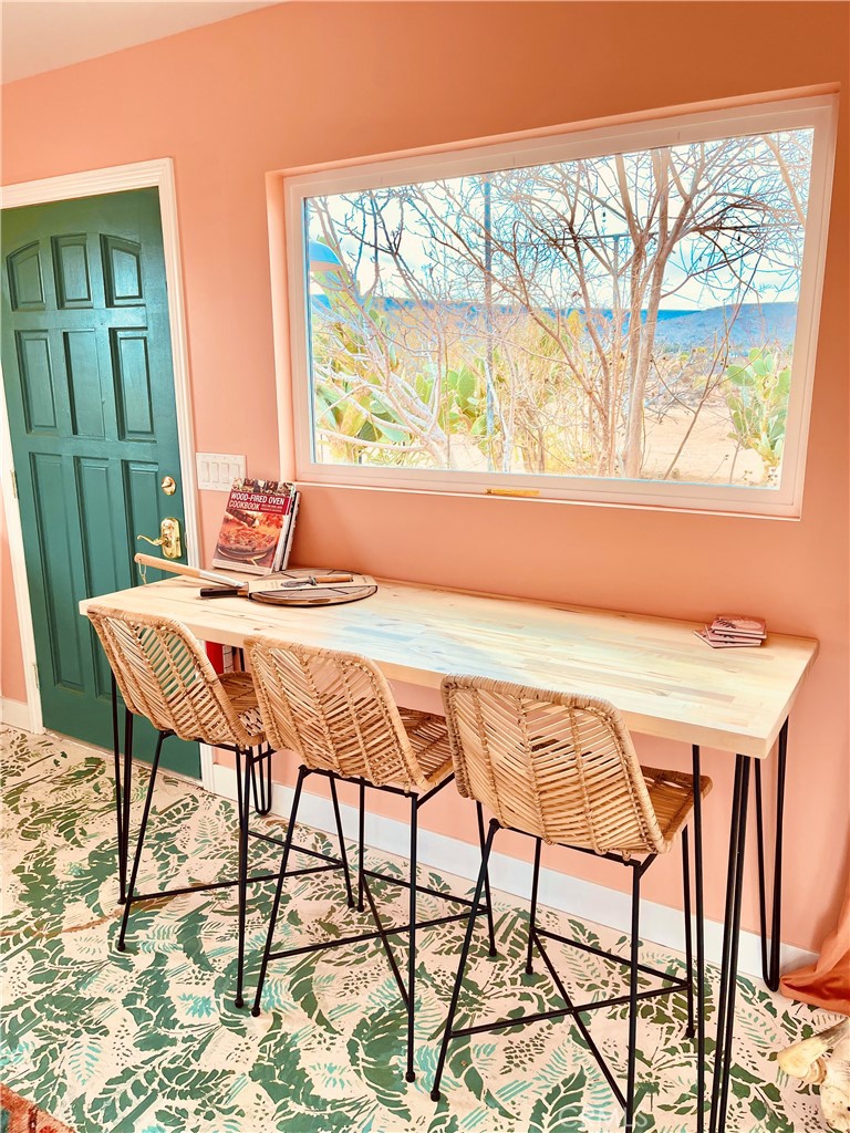 56345 Moonstone Road Yucca Valley, CA 92284 - Photo 10 of 69 a view of a dining room with furniture and a large window
