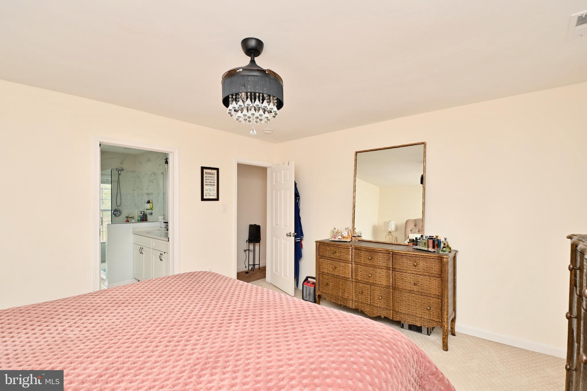 6431 Forest Road Landover, MD 20785 - Photo 21 of 42 a bedroom with a bed and a chandelier