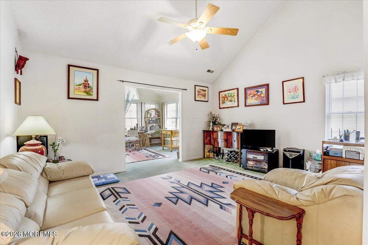 24 Merion Lane Jackson, NJ 08527 - Photo 12 of 45 a living room with furniture a flat screen tv and a fireplace