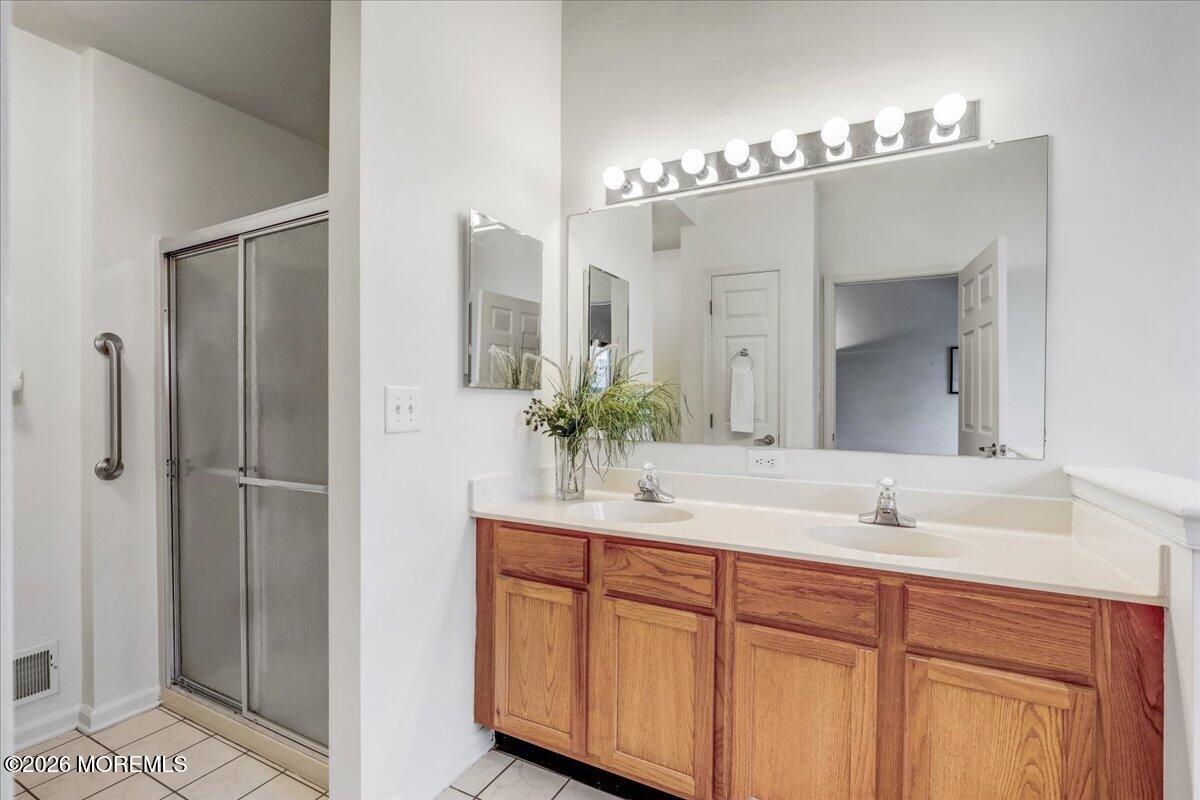 24 Merion Lane Jackson, NJ 08527 - Photo 20 of 45 a bathroom with a double vanity sink and mirror
