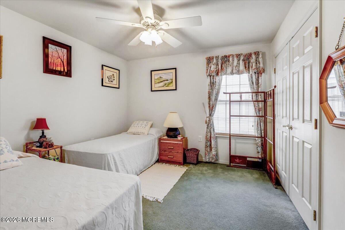 24 Merion Lane Jackson, NJ 08527 - Photo 22 of 45 a bedroom with a bed and a chandelier