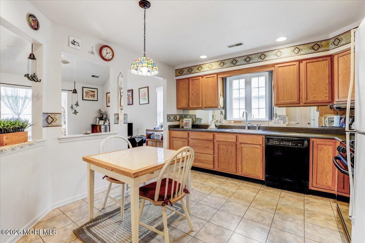 24 Merion Lane Jackson, NJ 08527 - Photo 9 of 45 a kitchen with a stove a sink a dining table and chairs