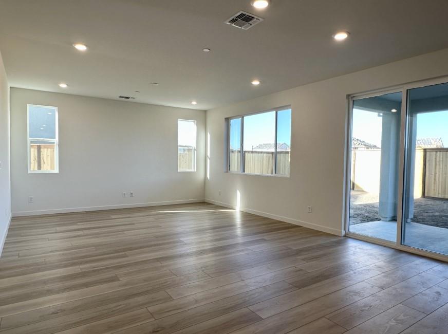 611 Willow Bend Lathrop, CA 95330 - Photo 2 of 11 an empty room with wooden floor and windows
