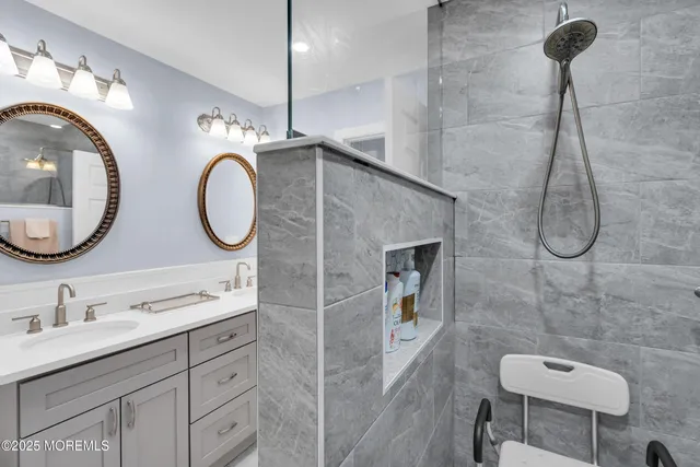 a bathroom with a double vanity sink and a mirror