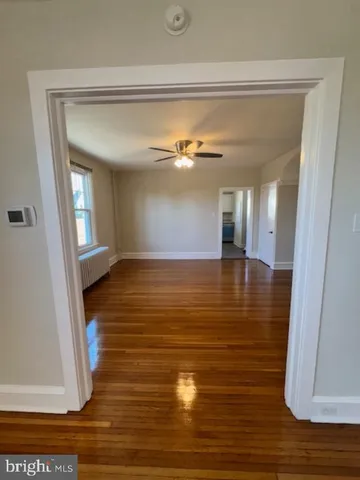 a view of a room with wooden floor