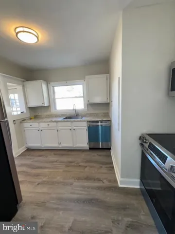 a view of a kitchen with a sink cabinets and a window