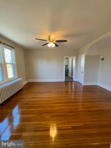 a view of a room with wooden floor and staircase