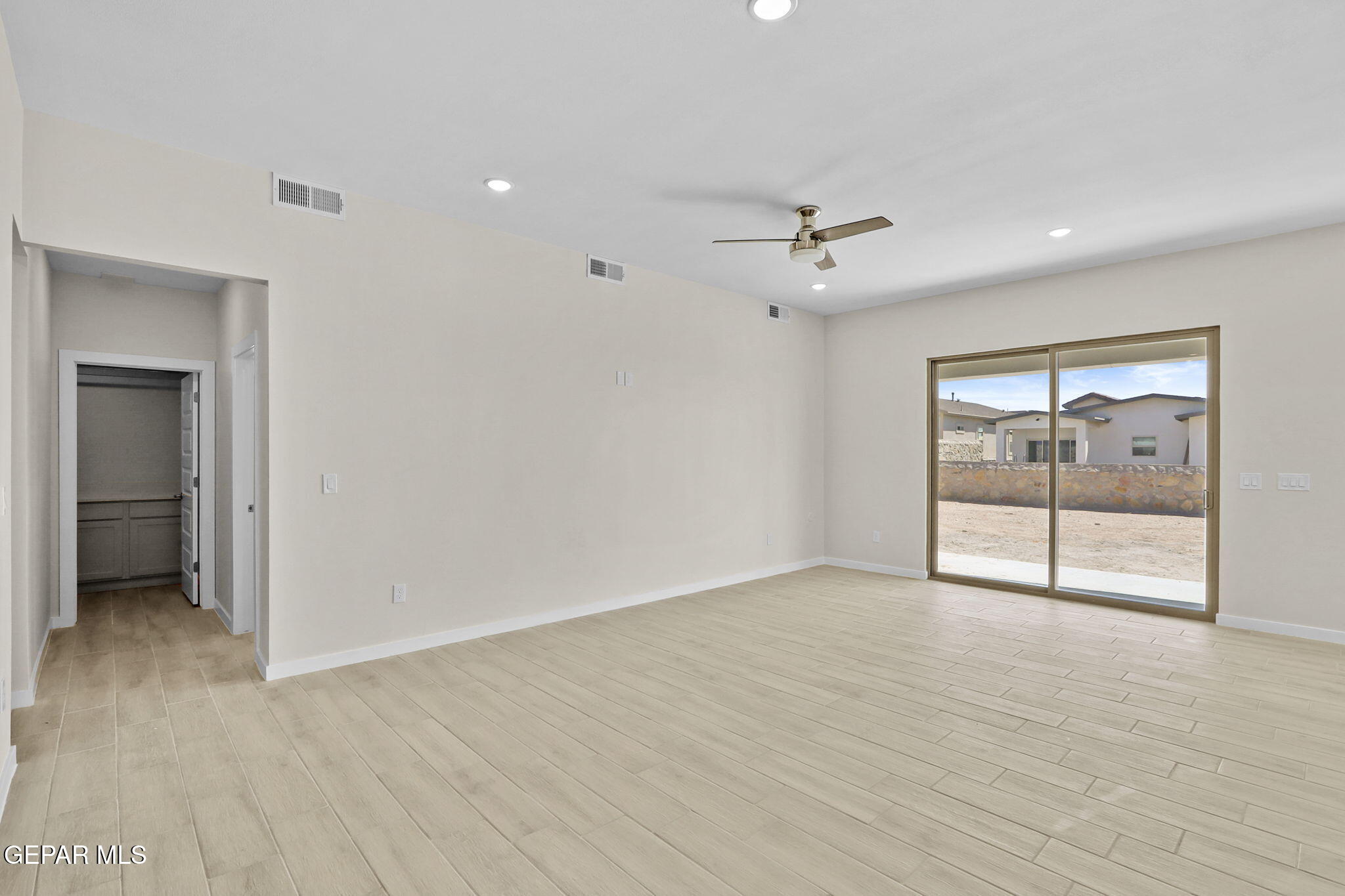 8409 Phil Place Vinton, TX 79821 - Photo 13 of 20 wooden floor in an empty room with a window
