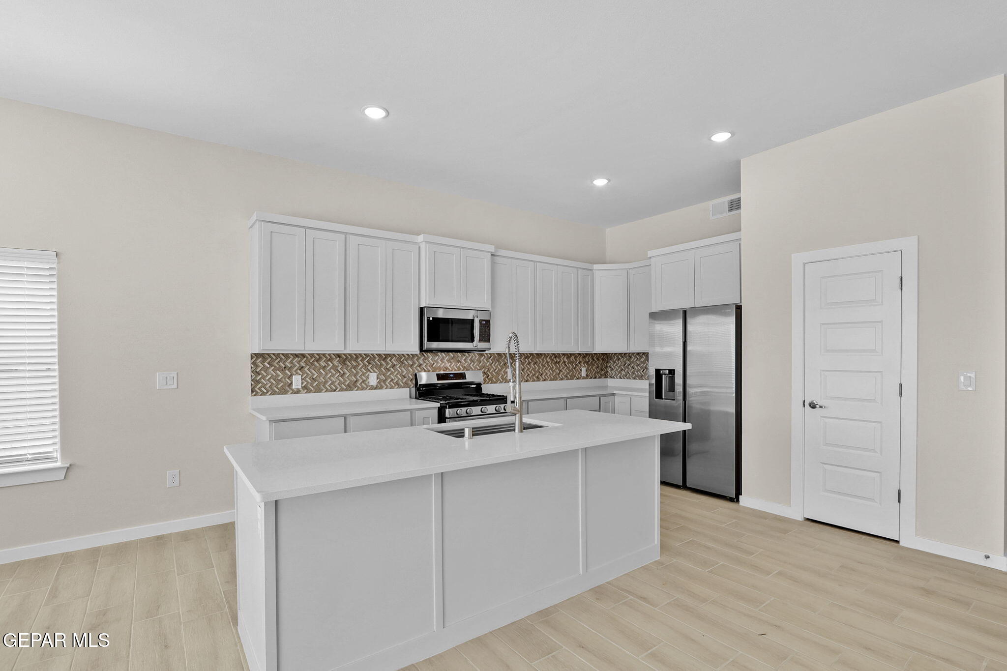 8409 Phil Place Vinton, TX 79821 - Photo 14 of 20 a kitchen with stainless steel appliances a refrigerator sink and stove