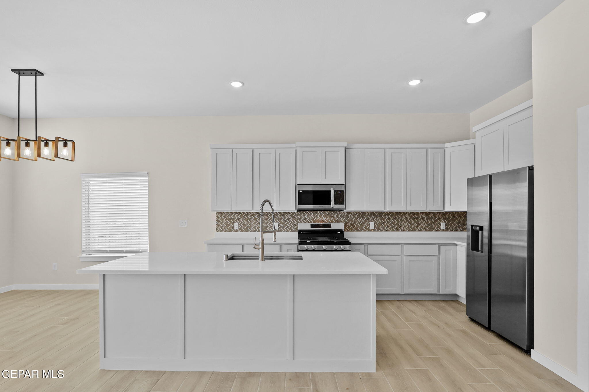 8409 Phil Place Vinton, TX 79821 - Photo 3 of 20 a kitchen with cabinets a sink and stainless steel appliances