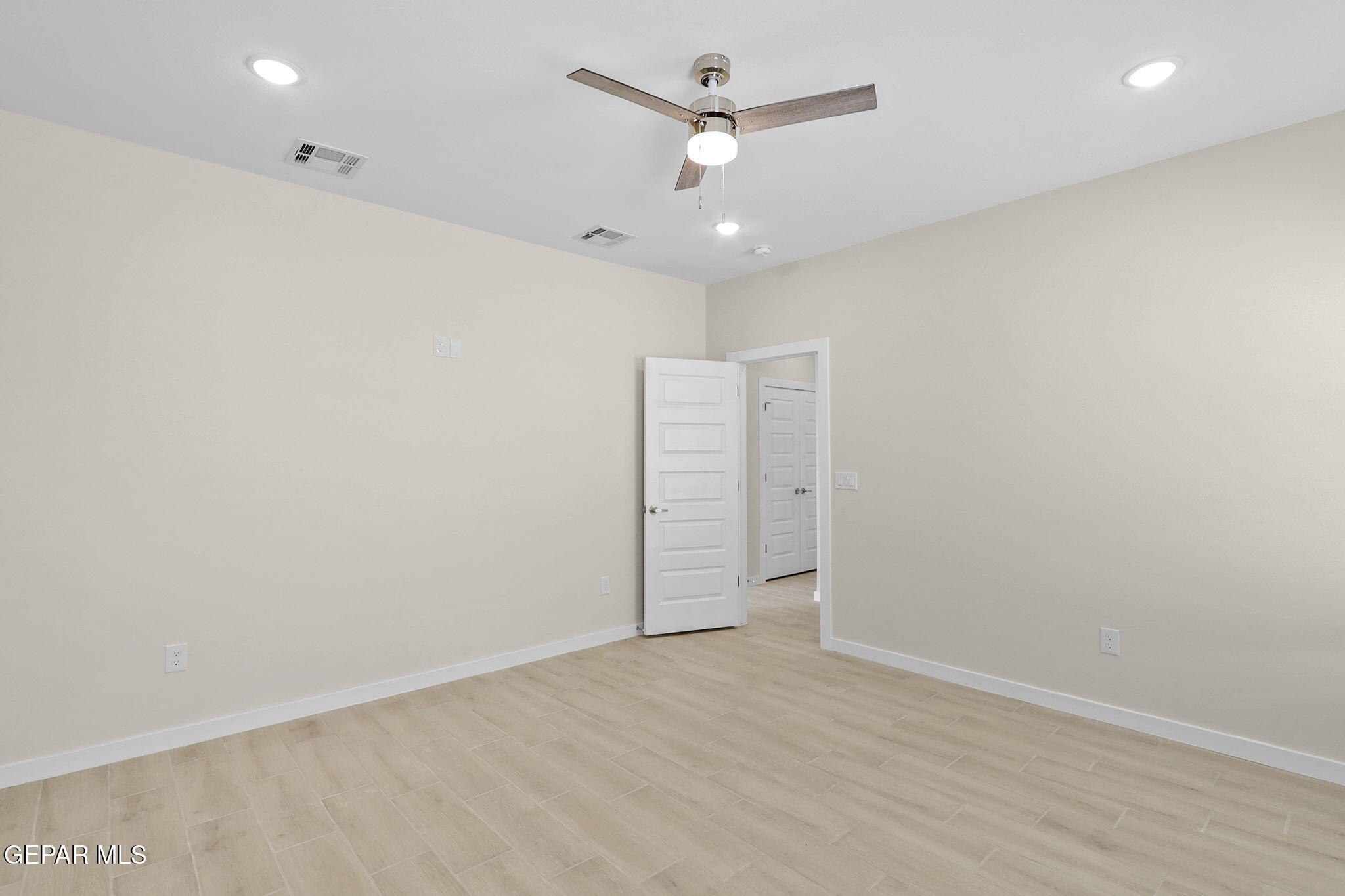 8409 Phil Place Vinton, TX 79821 - Photo 7 of 20 an empty room with a fan & a ceiling fan