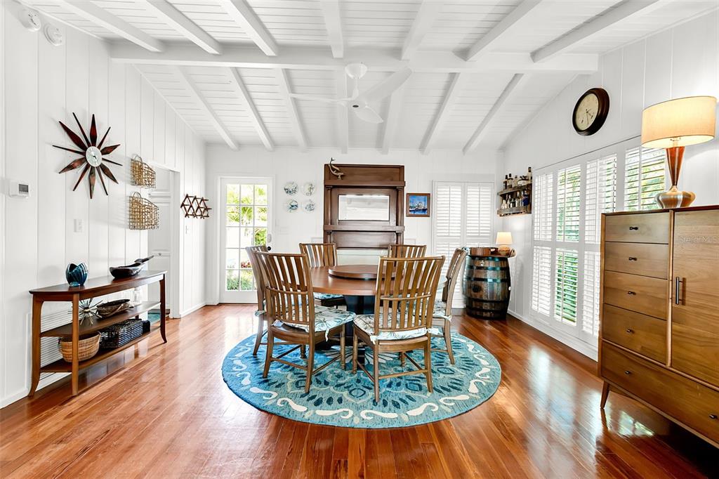 621 Casey Key Road Nokomis, FL 34275 - Photo 12 of 51 a dining room with furniture and wooden floor
