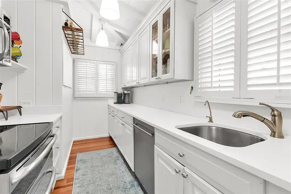 a kitchen that has a sink and a stove