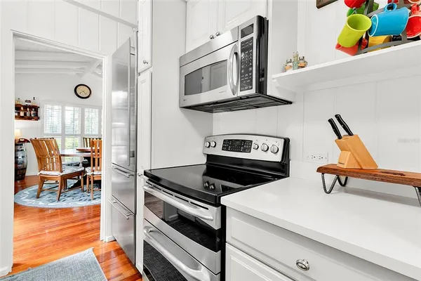 a kitchen with stainless steel appliances a stove a microwave and cabinets