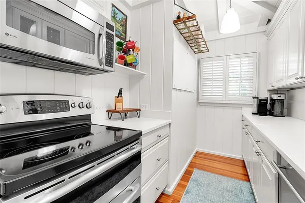a kitchen with stainless steel appliances granite countertop a stove and a microwave
