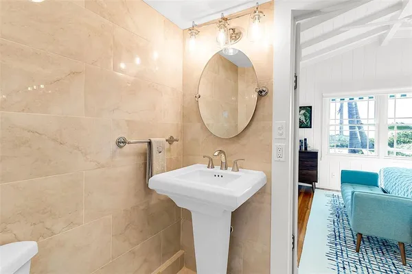 a bathroom with a sink a mirror and a shower