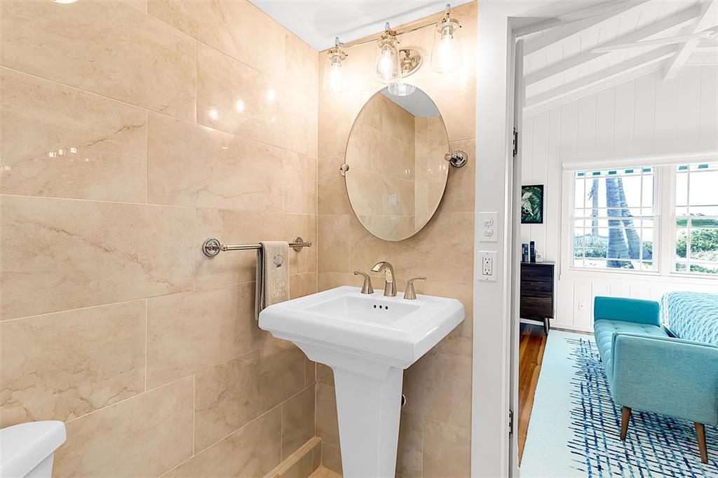 621 Casey Key Road Nokomis, FL 34275 - Photo 22 of 51 a bathroom with a sink a mirror and a shower