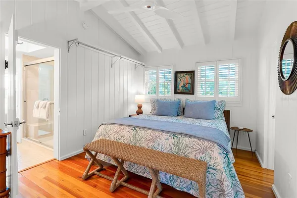 a bed sitting in a bedroom next to a window