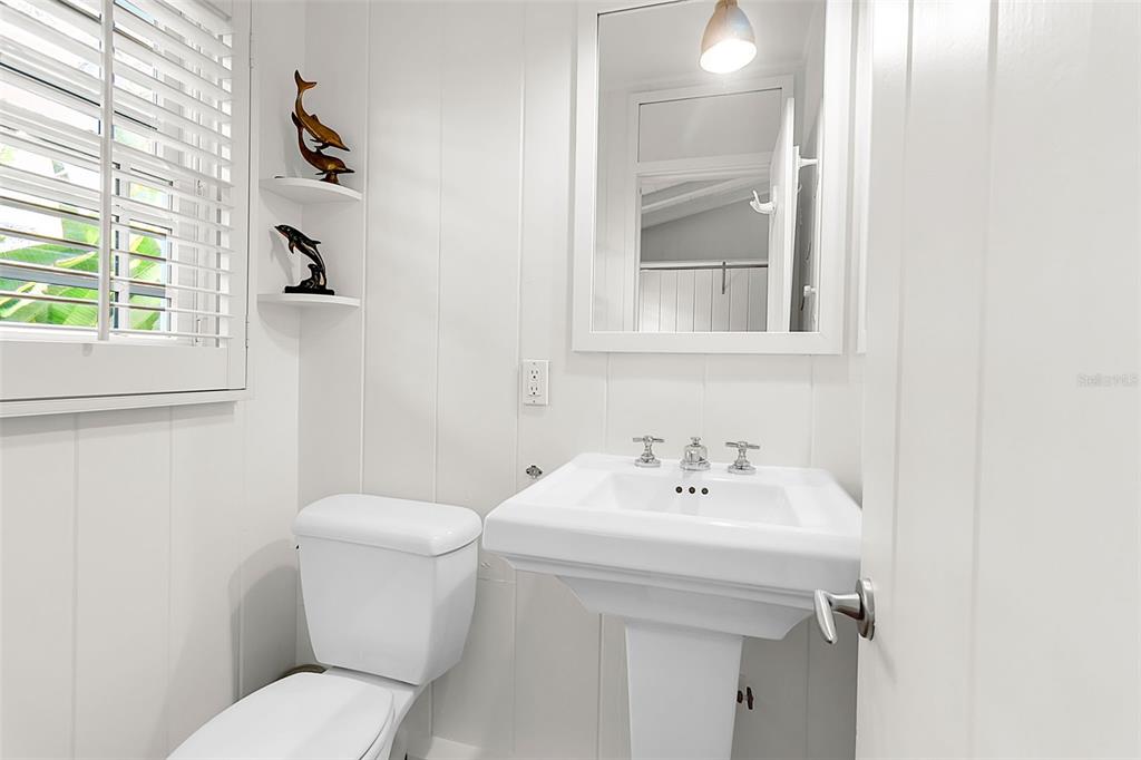 621 Casey Key Road Nokomis, FL 34275 - Photo 24 of 51 a bathroom with a sink a toilet and a mirror